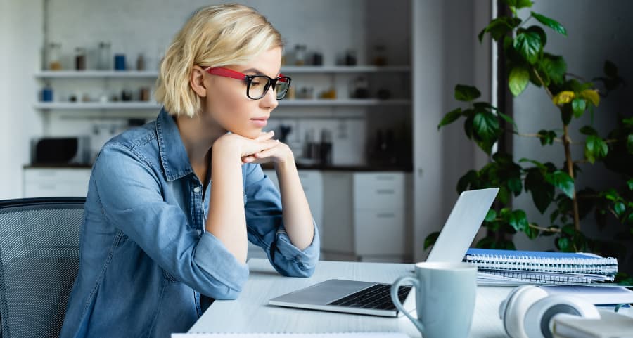 Young professional using laptop in home office